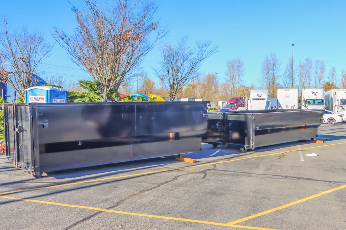 Professional dumpster rental service with roll-off container on residential driveway in Clarksville